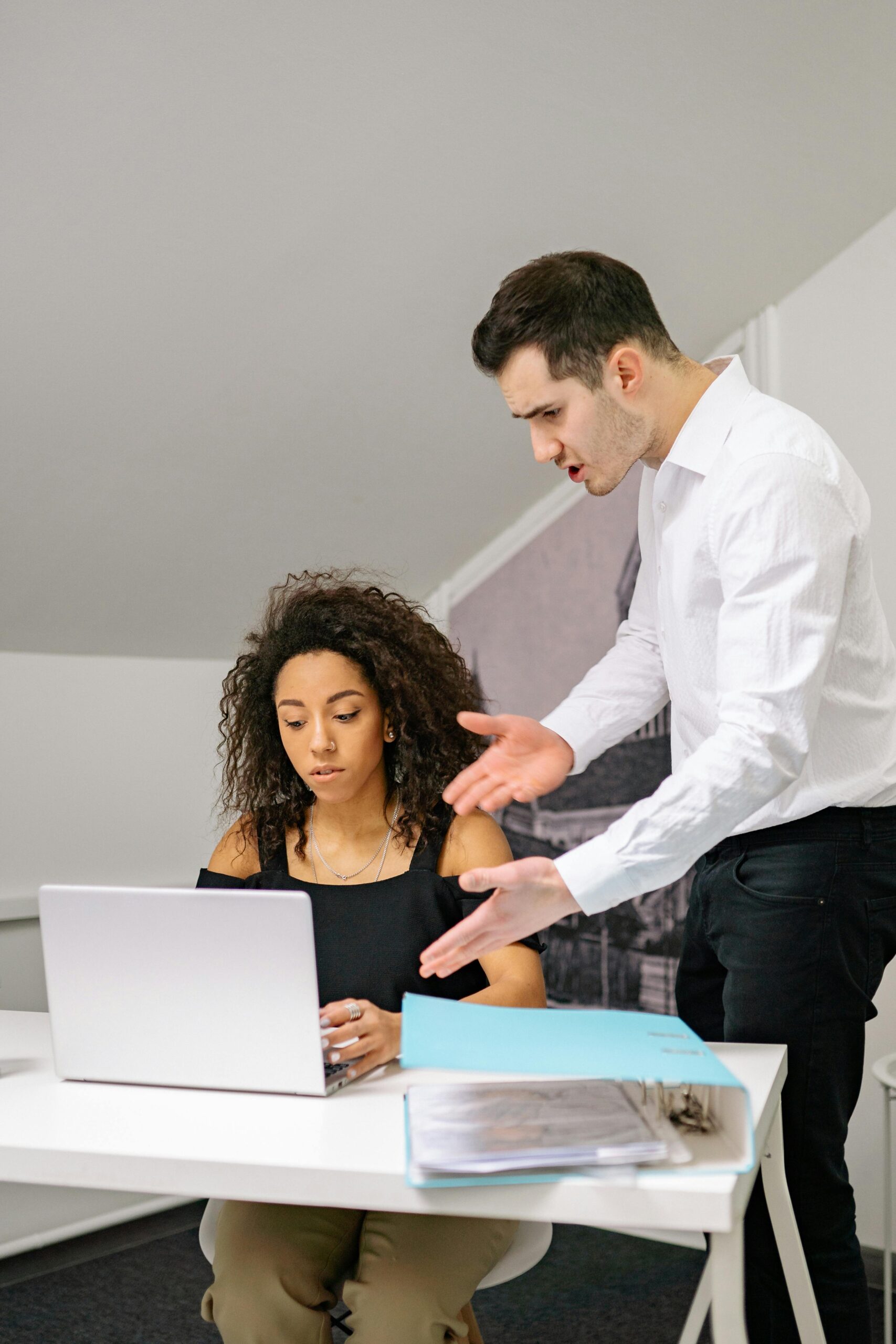 Colleagues in a heated discussion at the workplace, showcasing teamwork and problem-solving.